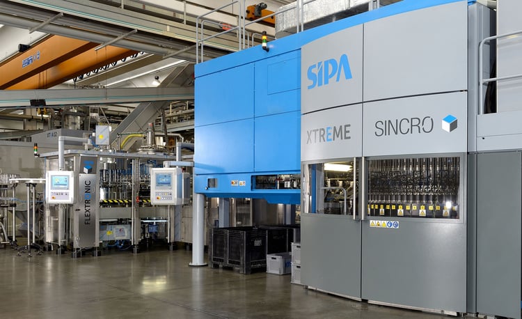 Integrating a linear blower with a rotary filling unit in PET bottling systems