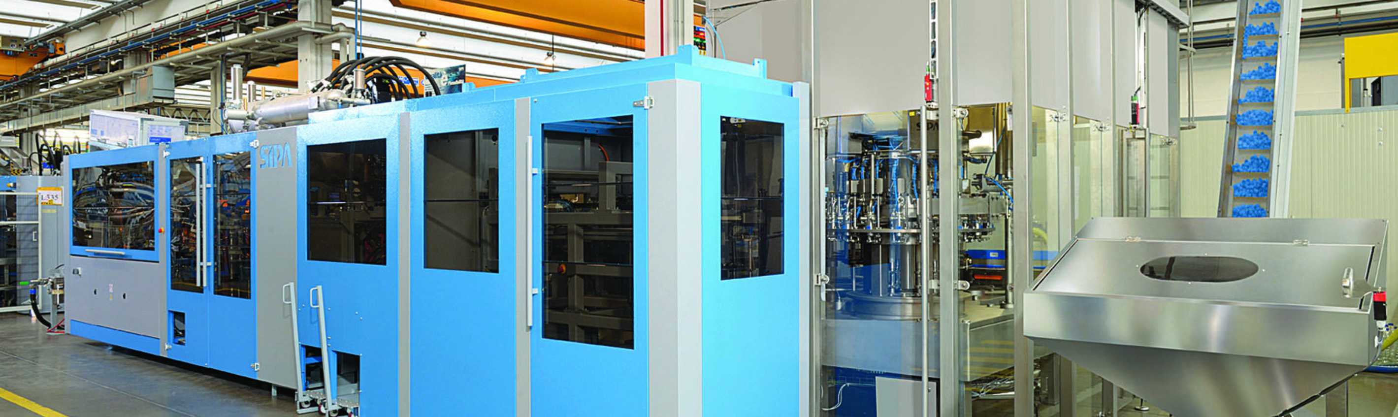 Integrating a linear blower with a rotary filling unit in PET bottling systems