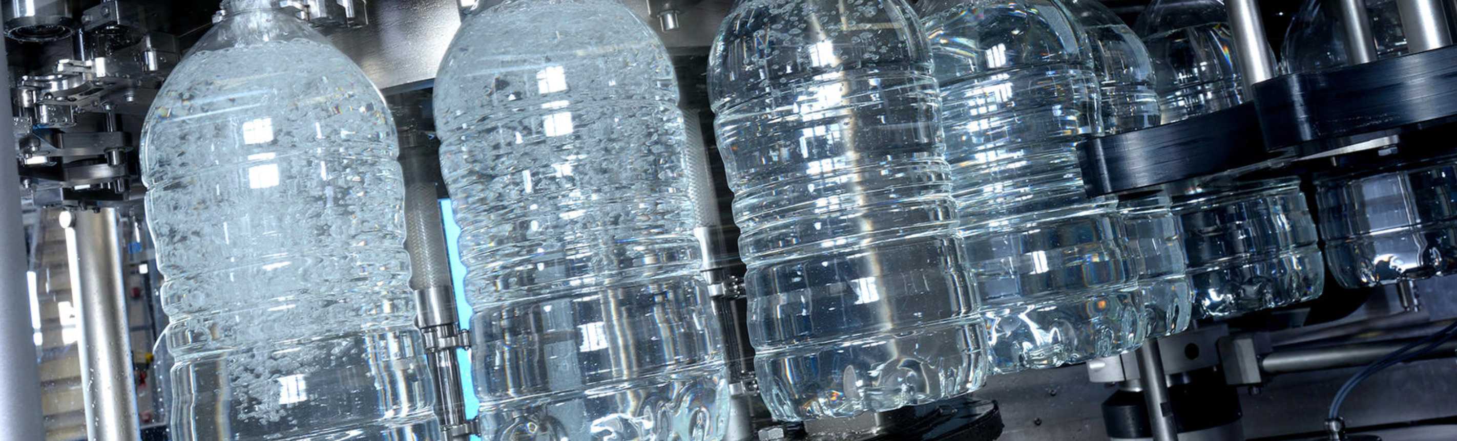 Integrating a linear blower with a rotary filling unit in PET bottling systems